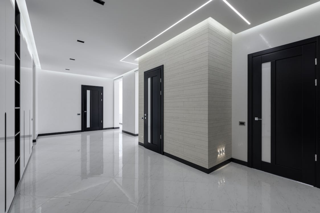 an apartment building with white tiles and a clear epoxy floor coating