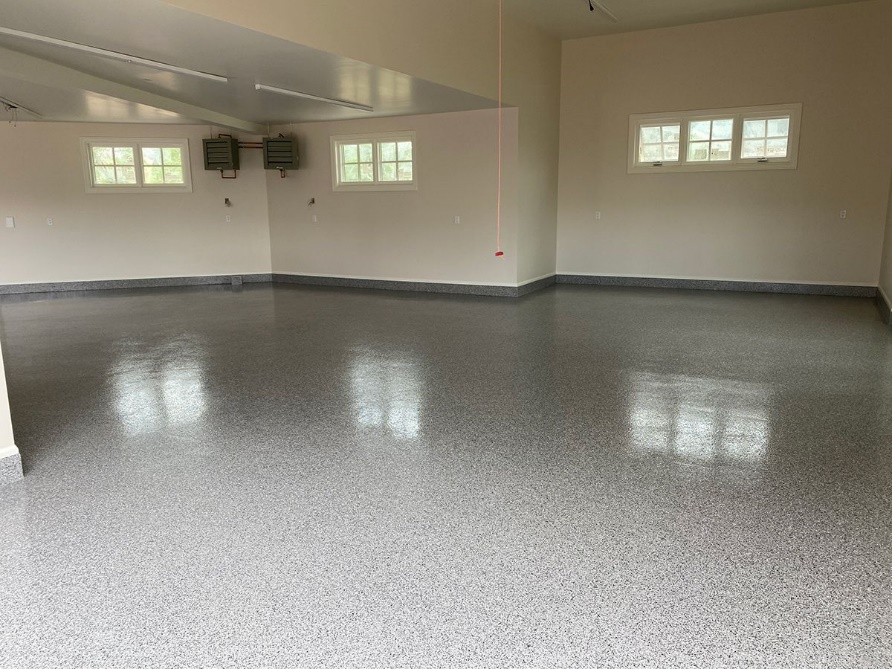 an empty large room with concrete epoxy floor