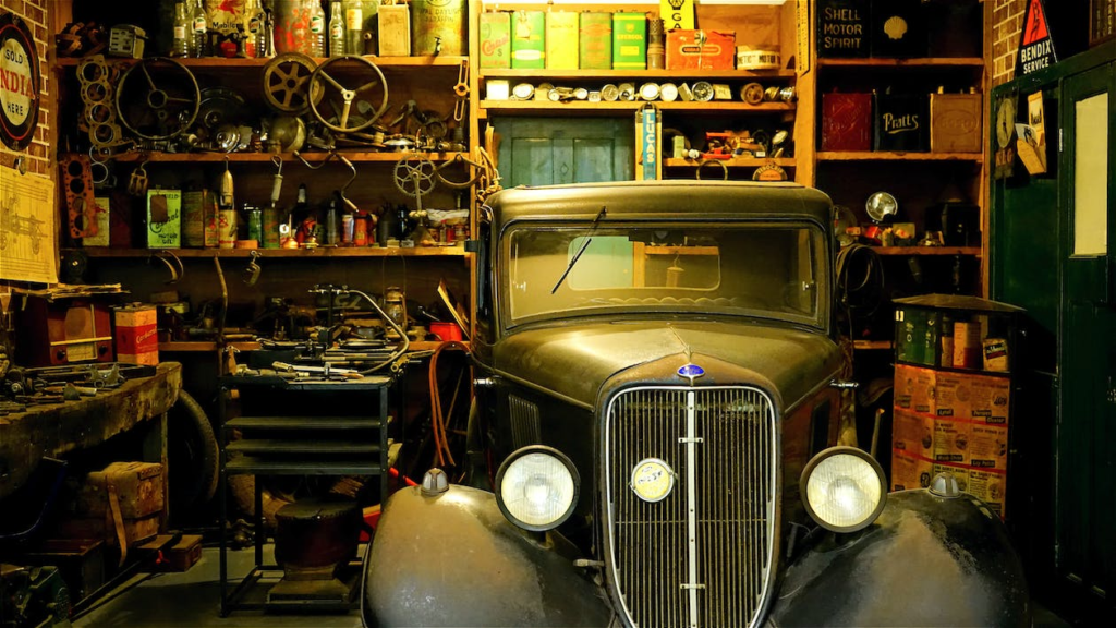 a garage with an older vehicle parked inside