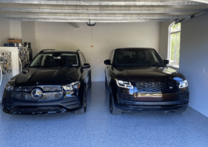 Two cars parked in a garage