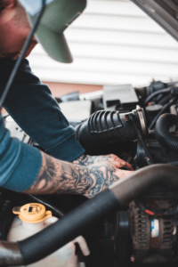 A man repairing a car engine